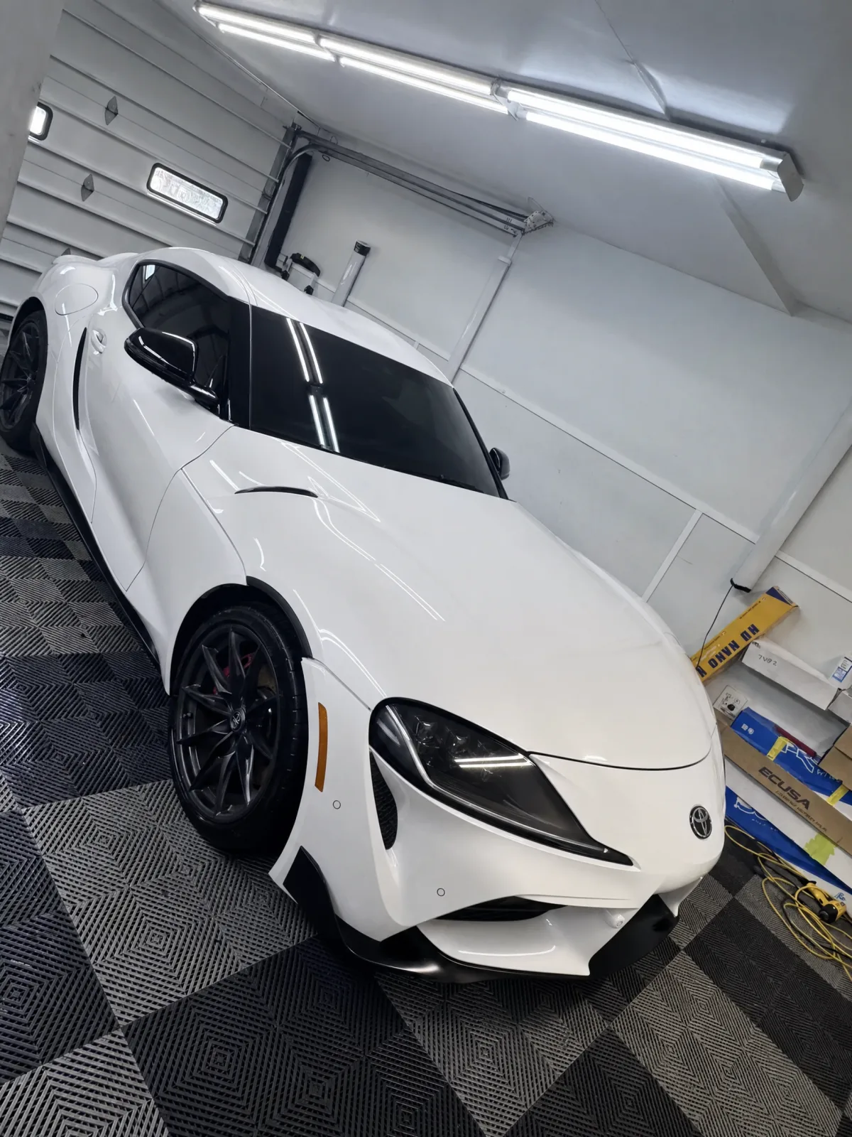 The same white GR Supra with the paint protection film laid smooth and invisible