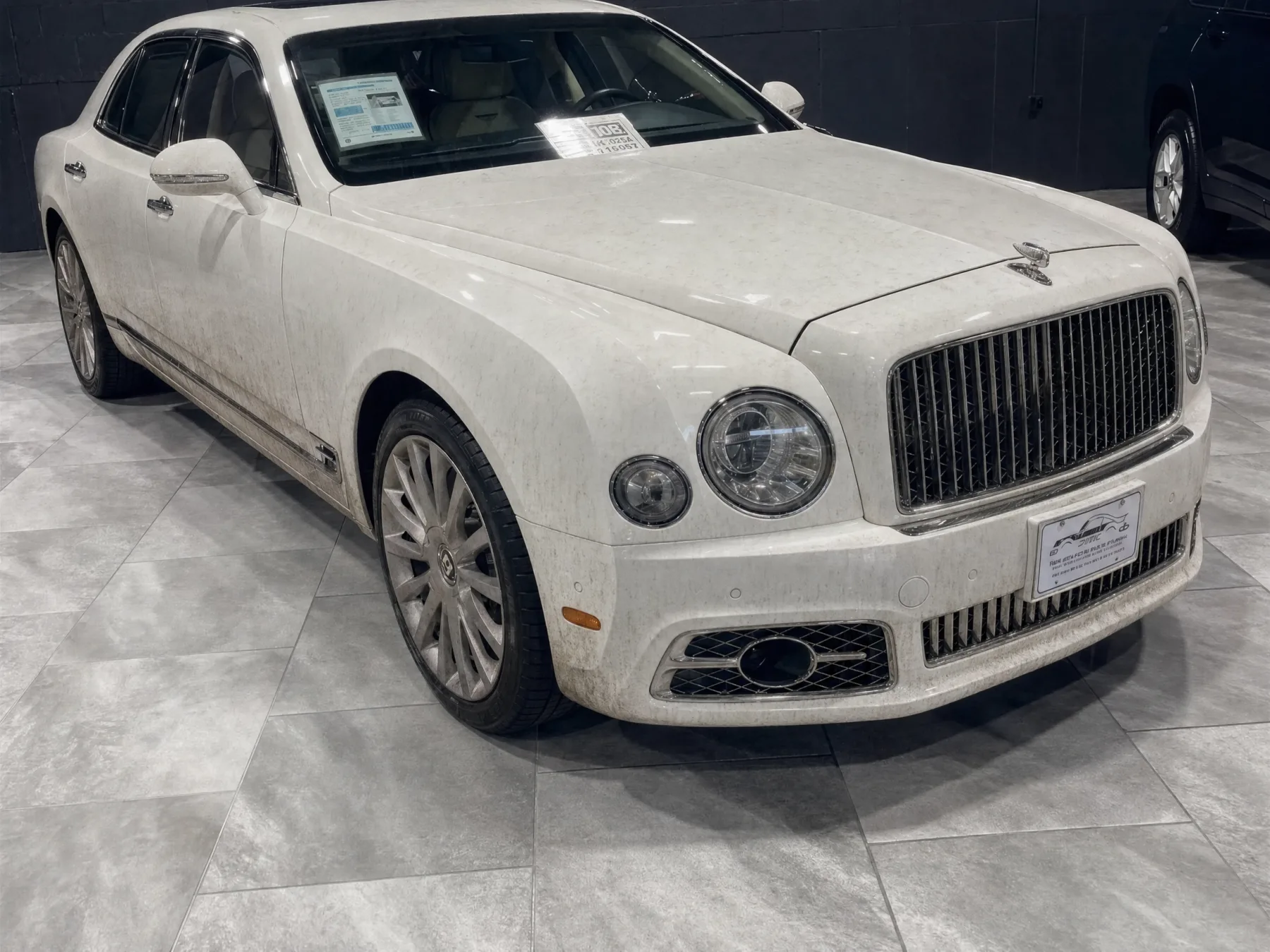 White Bentley Mulsanne with dull paint, water spots and brake dust before detailing