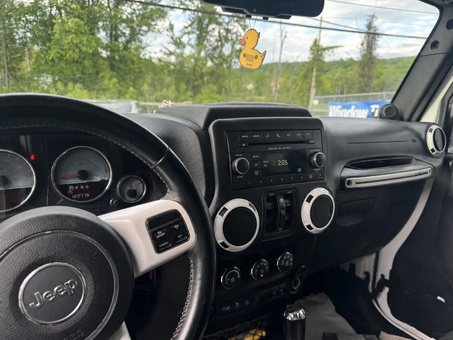 Jeep Wrangler dash with the small factory radio before the CarPlay upgrade