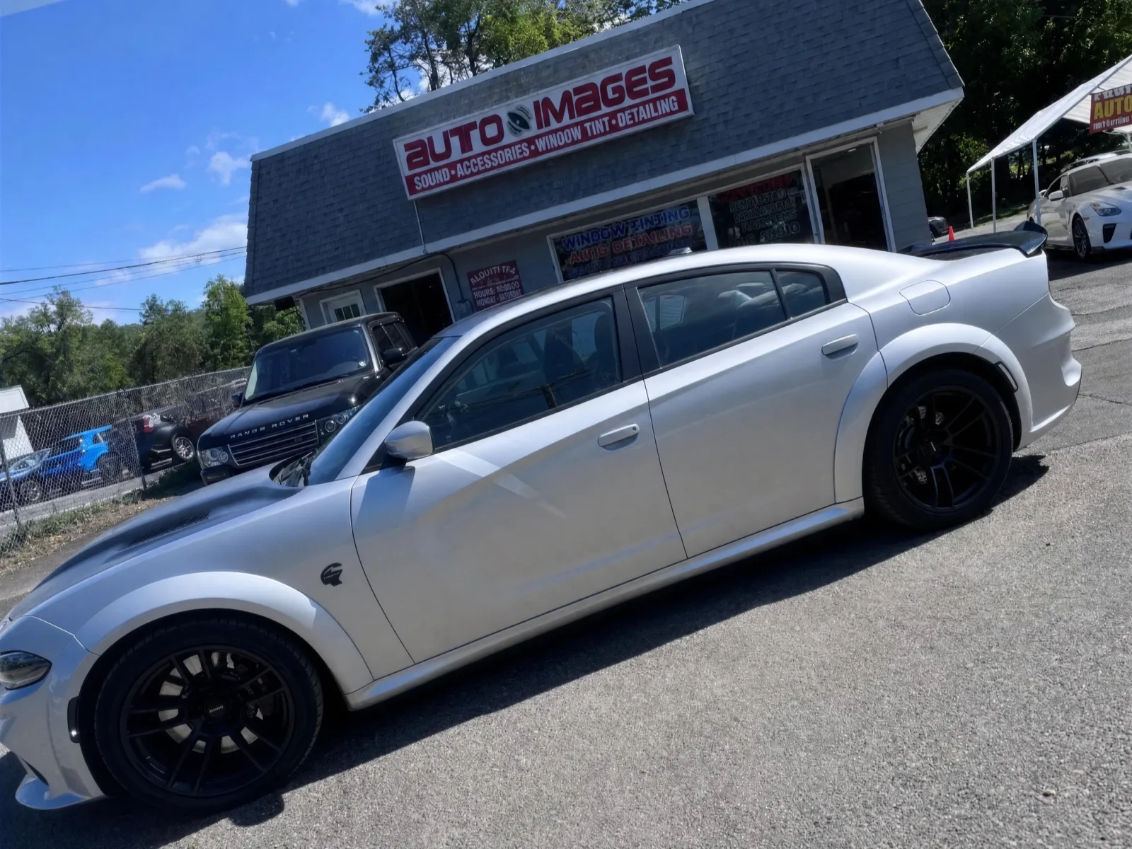 Silver widebody Dodge Charger Hellcat in plain silver with clear windows before tint and graphics