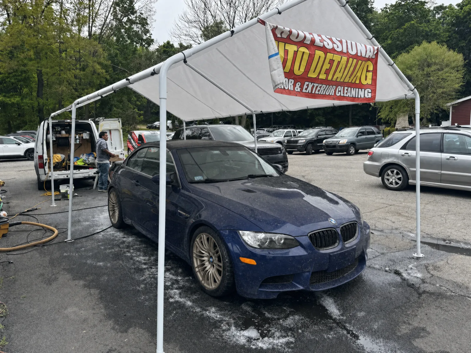 Blue BMW E93 M3 convertible covered in road film and brake dust before detailing