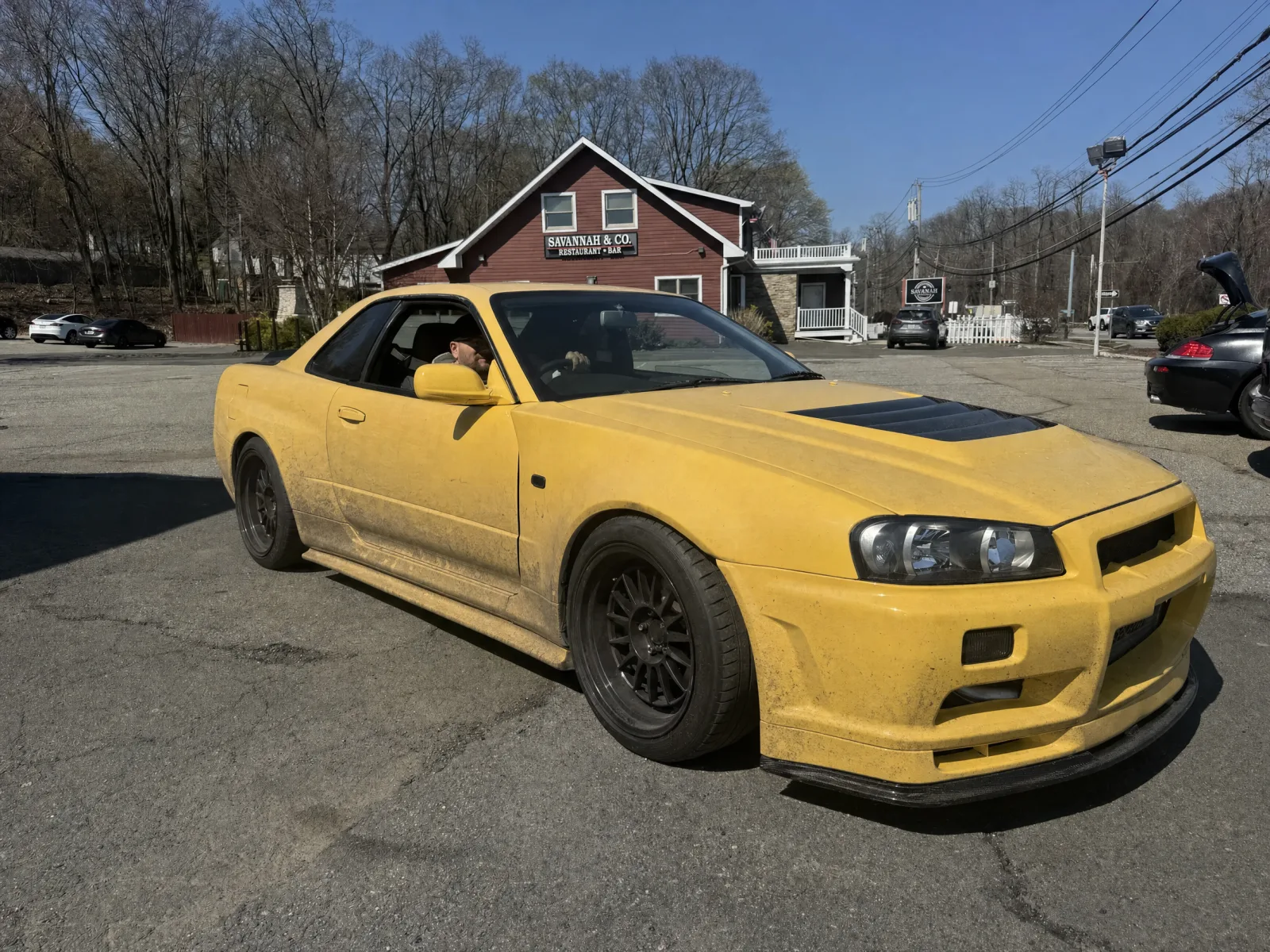 Yellow R34 Nissan Skyline dull under road film before its wash