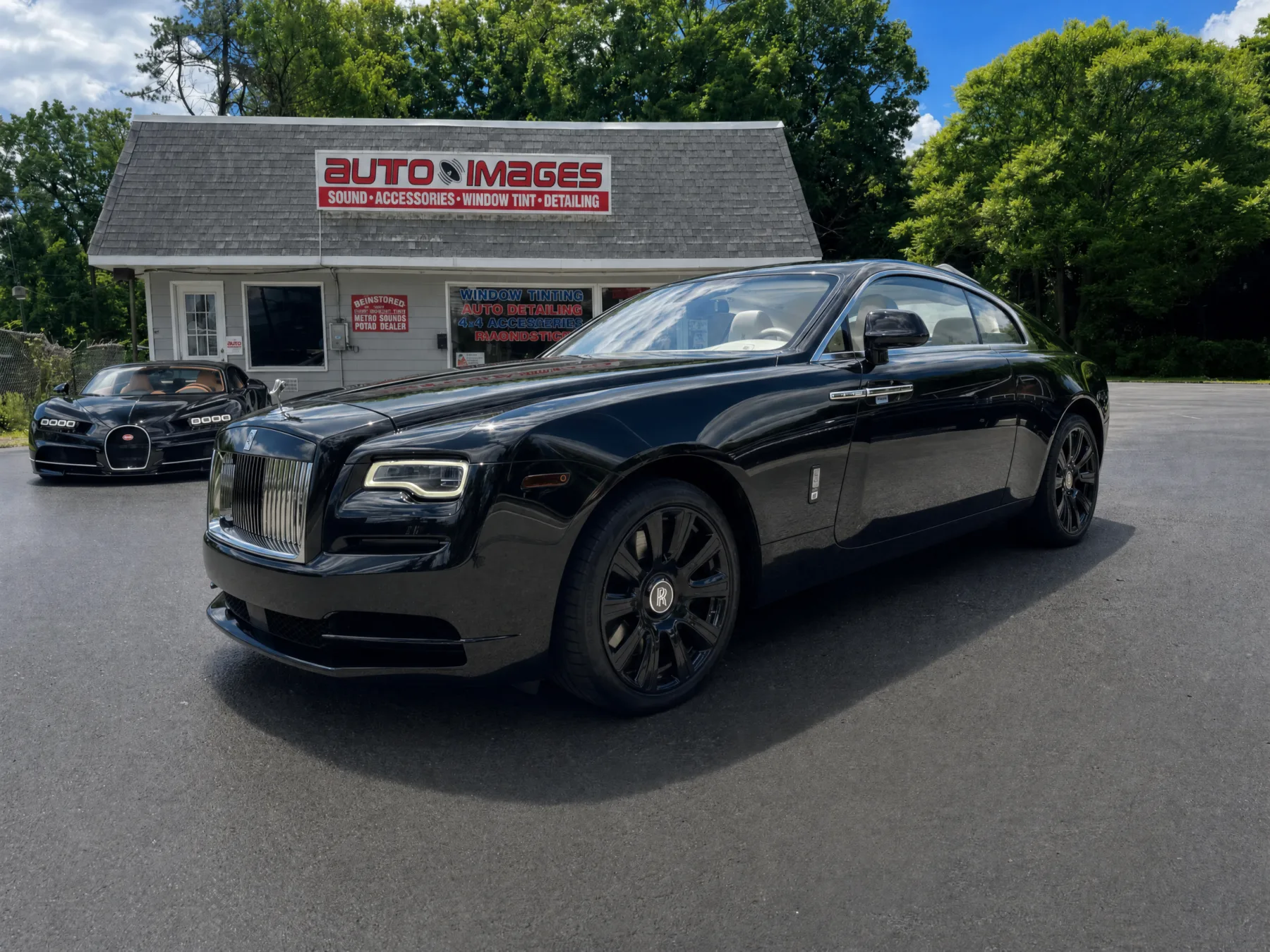 Black Rolls-Royce Wraith with factory-clear glass at the Auto Images shop