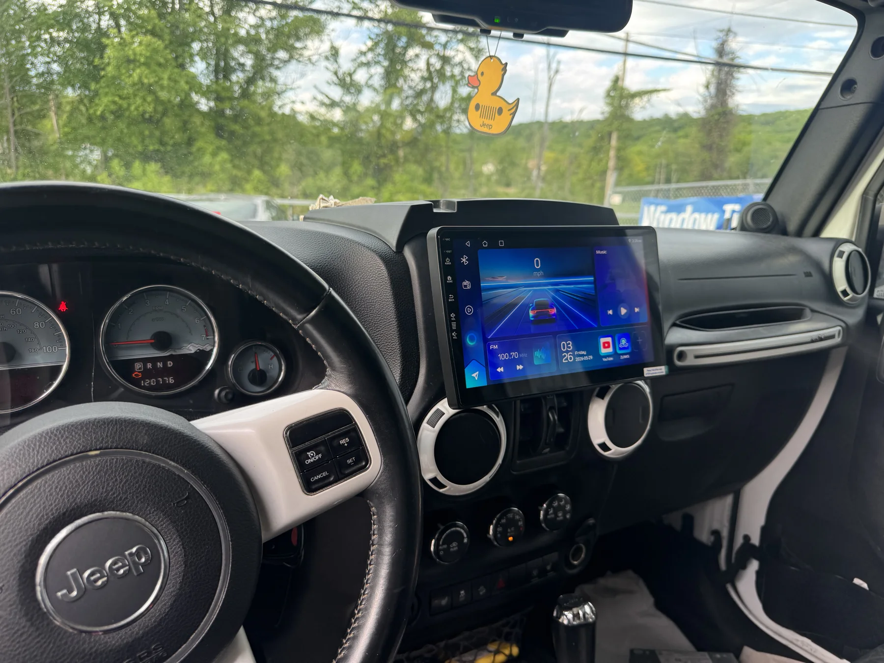 Jeep Wrangler dash with a newly installed 10-inch wireless CarPlay touchscreen