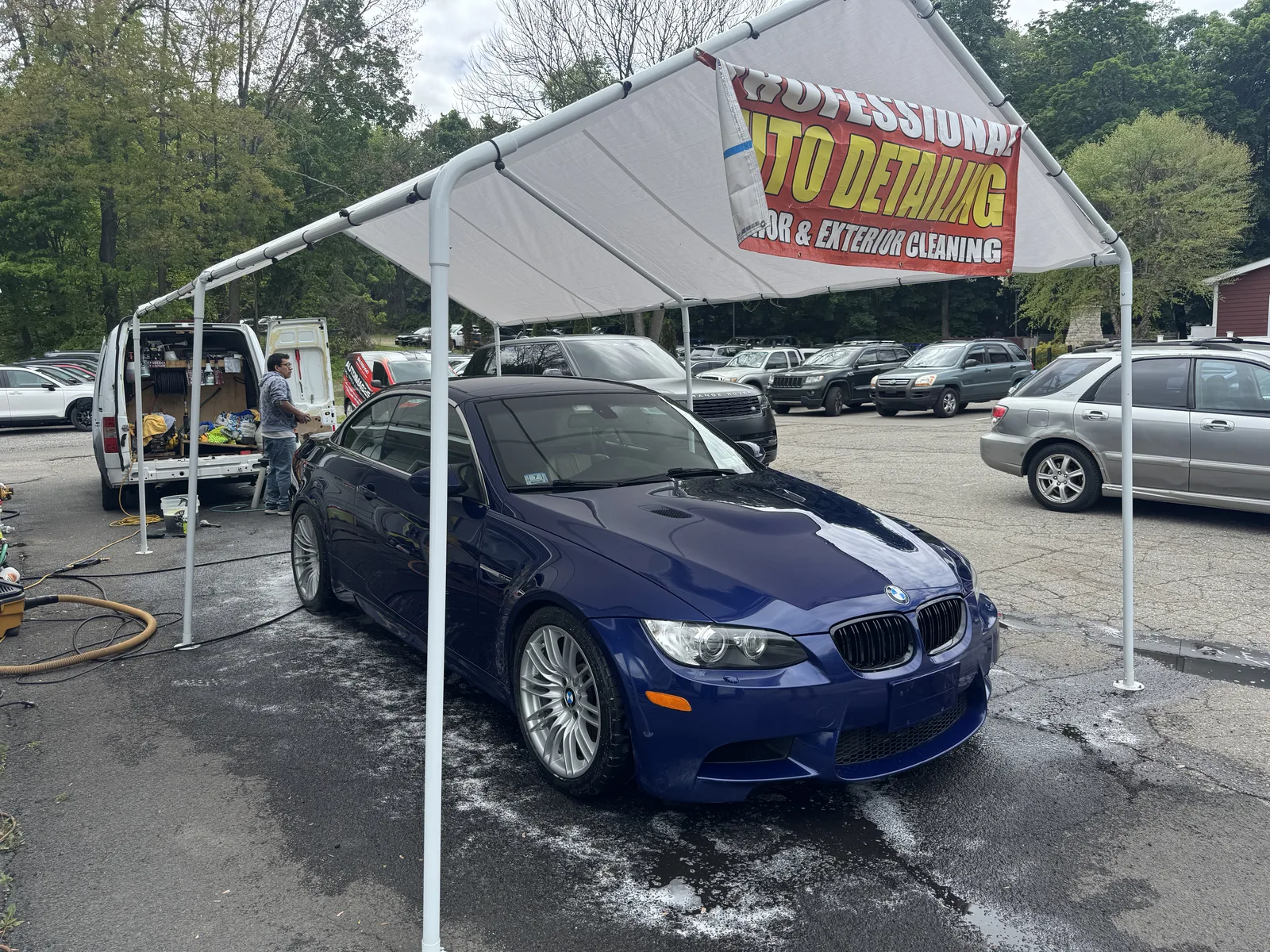 Blue BMW E93 M3 convertible washed and glossy under the Auto Images detailing canopy