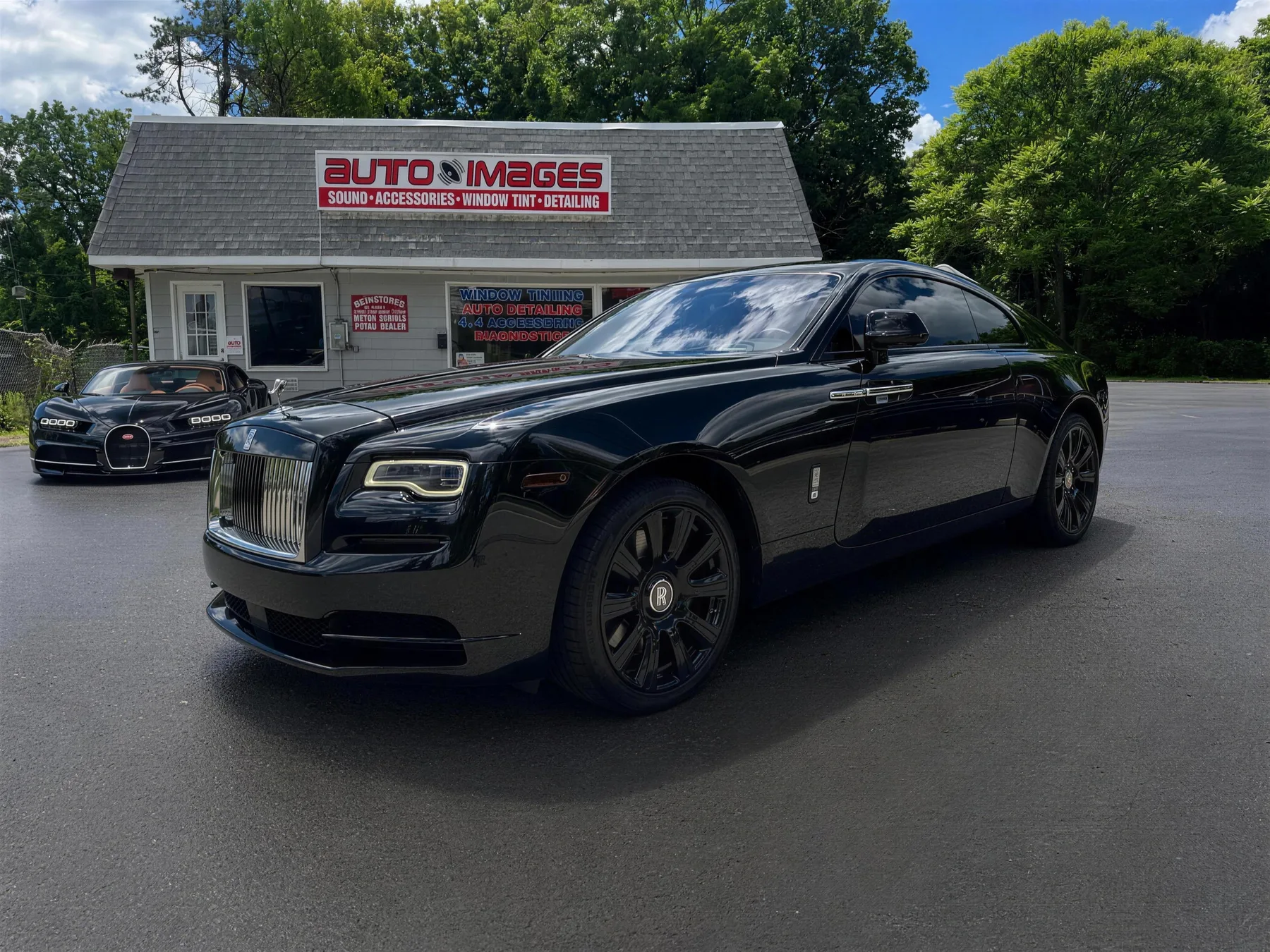 Black Rolls-Royce Wraith blacked out nose to tail with ceramic tint at the Auto Images shop
